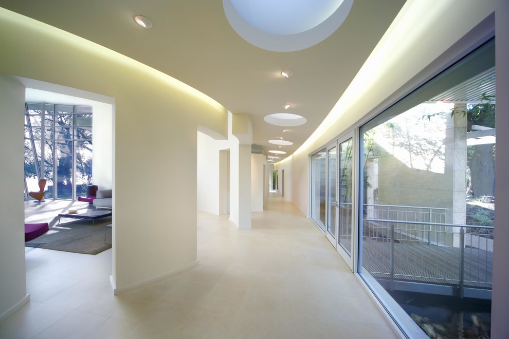 Inspiration for a large modern hallway in San Francisco with white walls and limestone floors.