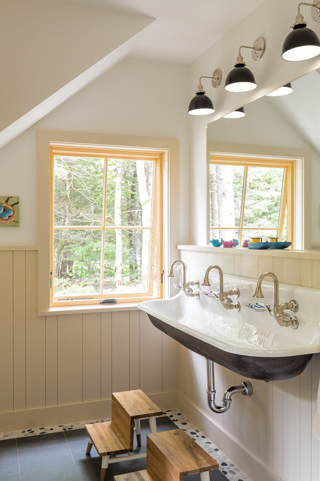 Photo of a country bathroom in Portland Maine with white walls, a wall-mount sink and grey floor.