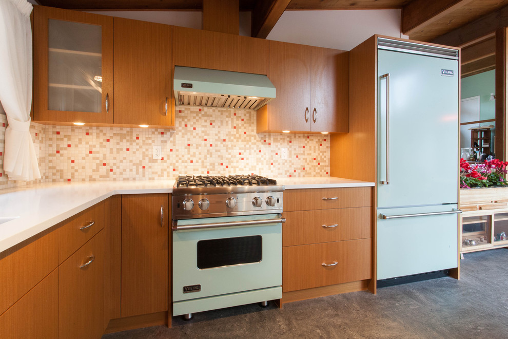 Design ideas for a modern kitchen in Vancouver with mosaic tile splashback, flat-panel cabinets, medium wood cabinets, multi-coloured splashback and coloured appliances.
