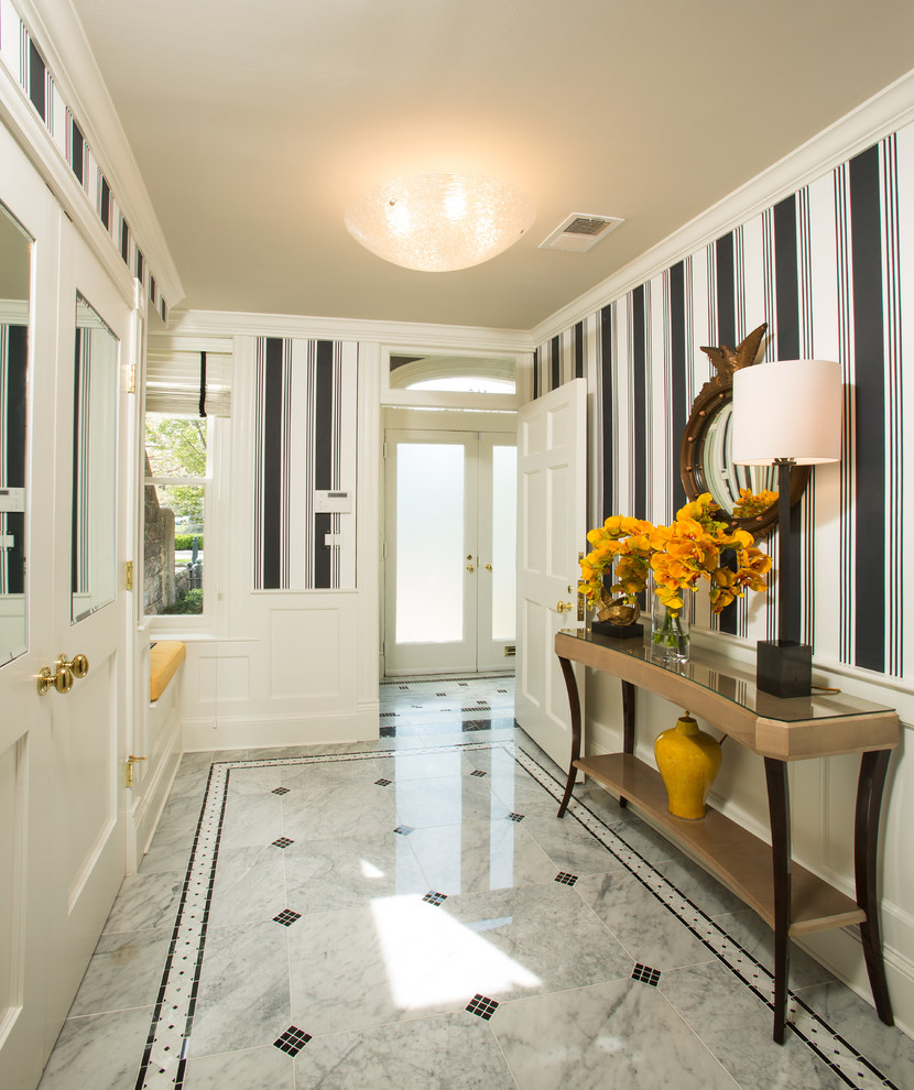 This is an example of a mid-sized transitional foyer in DC Metro with marble floors, a double front door, a white front door and grey floor.