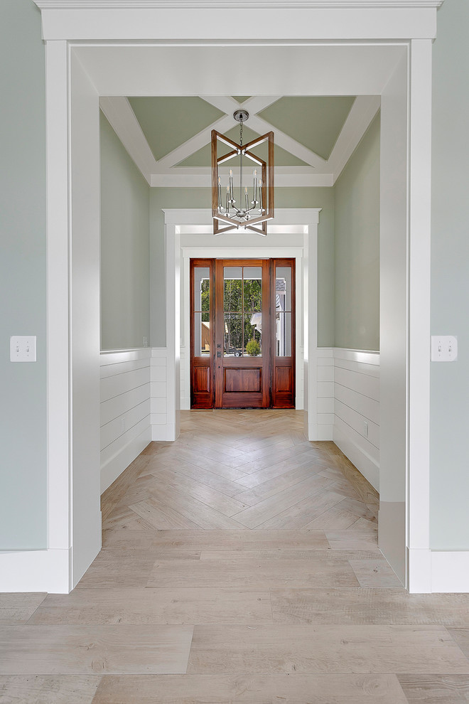 Large beach style foyer in Charleston with grey walls, a single front door and a dark wood front door.