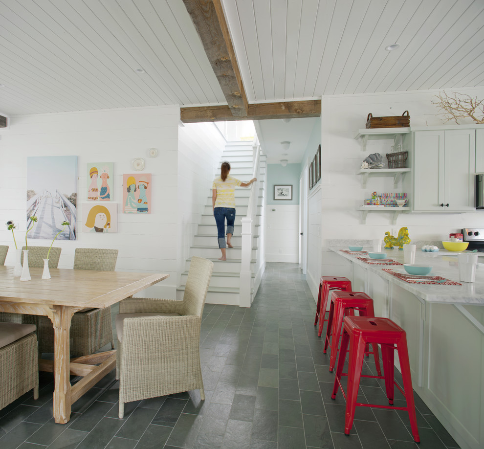 This is an example of a large beach style eat-in kitchen in Atlanta with shaker cabinets, grey cabinets, marble benchtops, grey floor, slate floors and with island.