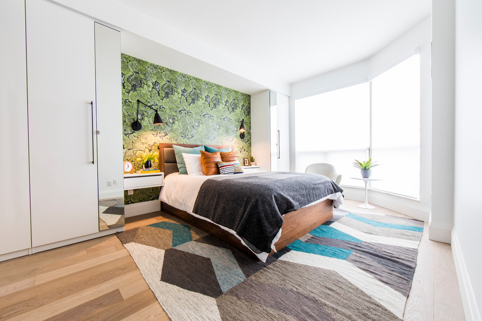 Contemporary bedroom in Toronto with white walls, medium hardwood floors and brown floor.