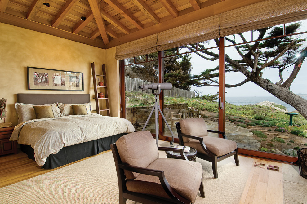 Design ideas for a beach style bedroom in San Francisco with beige walls and medium hardwood floors.
