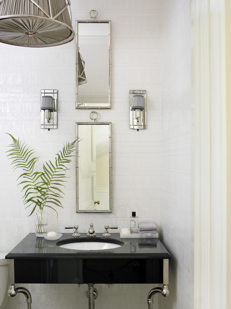 Inspiration for a traditional powder room in Atlanta with a console sink.