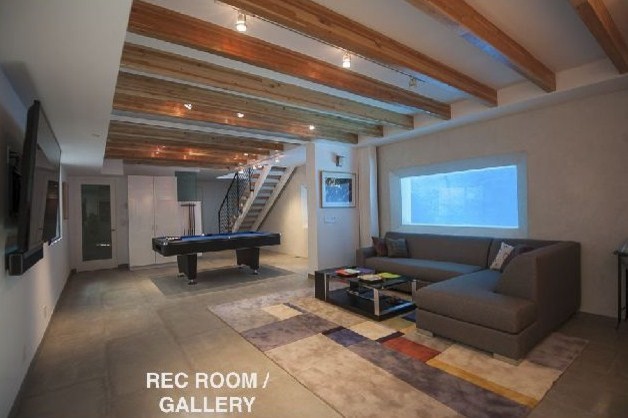 Large trendy enclosed concrete floor game room photo in Orange County with white walls