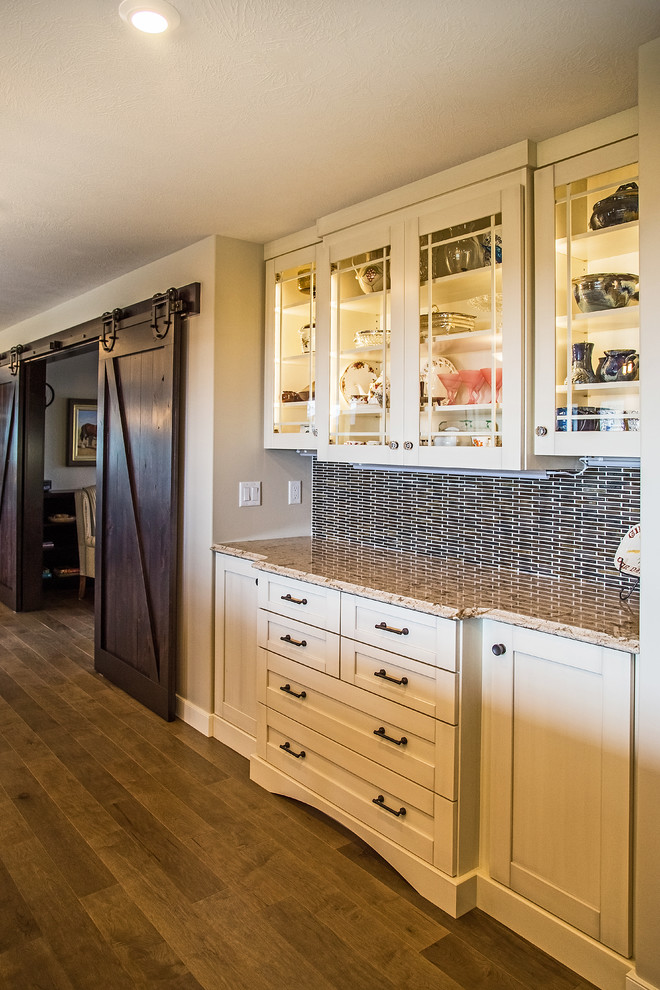 Kitchen - transitional medium tone wood floor kitchen idea in Calgary with an undermount sink, shaker cabinets, white cabinets, quartz countertops, white backsplash, porcelain backsplash and stainless steel appliances