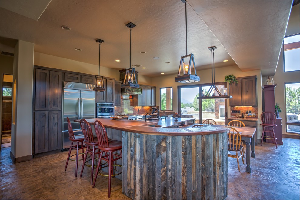Large mountain style galley concrete floor eat-in kitchen photo in Phoenix with a triple-bowl sink, shaker cabinets, gray cabinets, copper countertops, brown backsplash, stone slab backsplash, stainless steel appliances and two islands