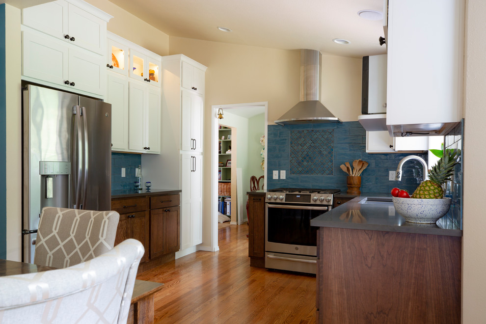 Example of a small transitional u-shaped medium tone wood floor and brown floor kitchen pantry design in Seattle with an undermount sink, shaker cabinets, white cabinets, quartz countertops, blue backsplash, porcelain backsplash, stainless steel appliances, no island and gray countertops