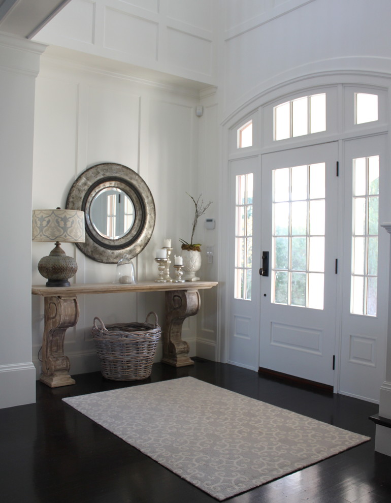 This is an example of a beach style entryway in Boston with dark hardwood floors, a single front door and a white front door.