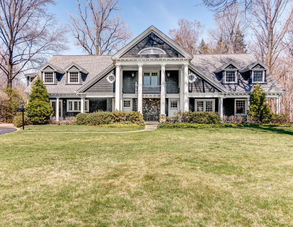 Example of a large classic gray two-story exterior home design in Cleveland