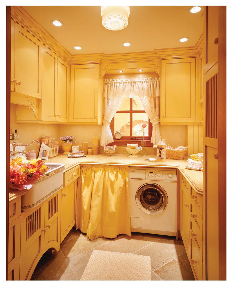 Inspiration for a mid-sized mediterranean single-wall utility room in San Francisco with an utility sink, recessed-panel cabinets, yellow cabinets, granite benchtops, beige walls, porcelain floors, a side-by-side washer and dryer and beige floor.