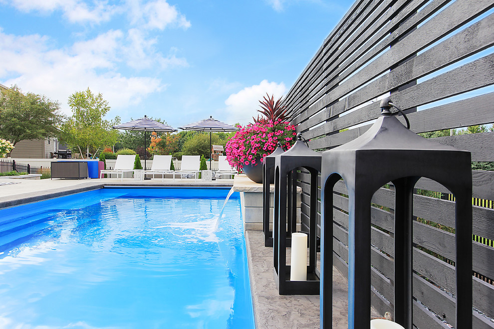 Pool fountain - large transitional backyard stamped concrete and rectangular lap pool fountain idea in Chicago