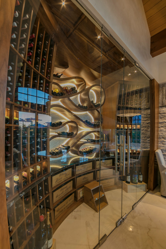 Photo of a small contemporary wine cellar in Calgary with marble floors and display racks.