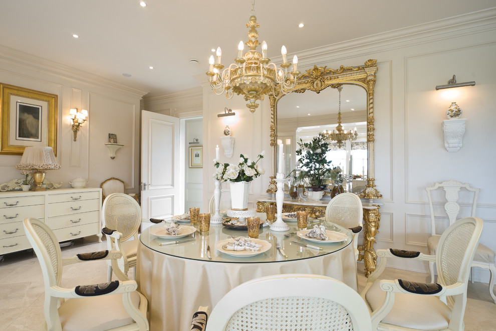 This is an example of a large traditional open plan dining in Dublin with white walls, limestone floors, a stone fireplace surround, no fireplace and beige floor.