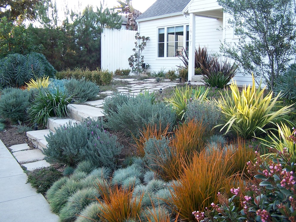 Mid-sized country front yard full sun formal garden in Los Angeles with a garden path and concrete pavers.