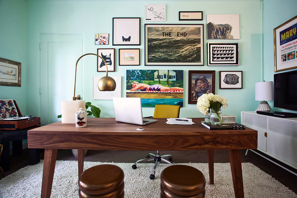 Photo of a midcentury home office in Los Angeles with blue walls, dark hardwood floors and a freestanding desk.
