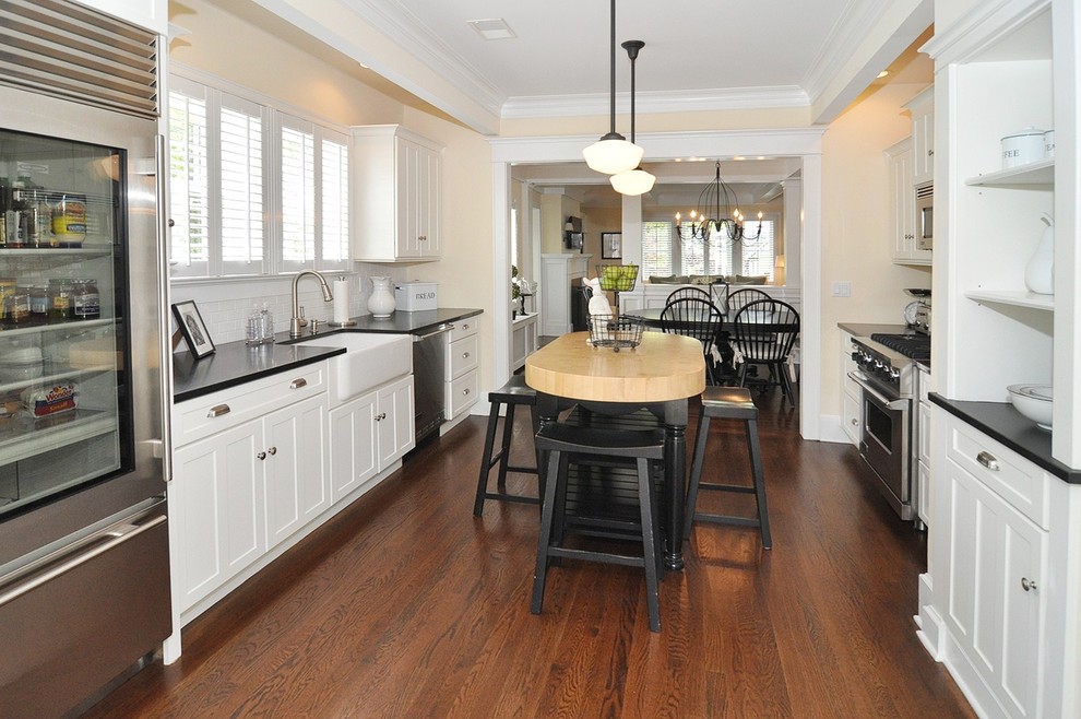 Photo of a traditional kitchen in New York with stainless steel appliances and a farmhouse sink.