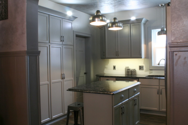 This is an example of a small transitional l-shaped separate kitchen in Other with a double-bowl sink, flat-panel cabinets, grey cabinets, quartz benchtops, stainless steel appliances, vinyl floors and with island.