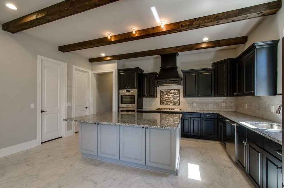 Inspiration for a mid-sized transitional l-shaped ceramic tile and white floor open concept kitchen remodel with an undermount sink, raised-panel cabinets, brown cabinets, granite countertops, white backsplash, ceramic backsplash, stainless steel appliances and an island