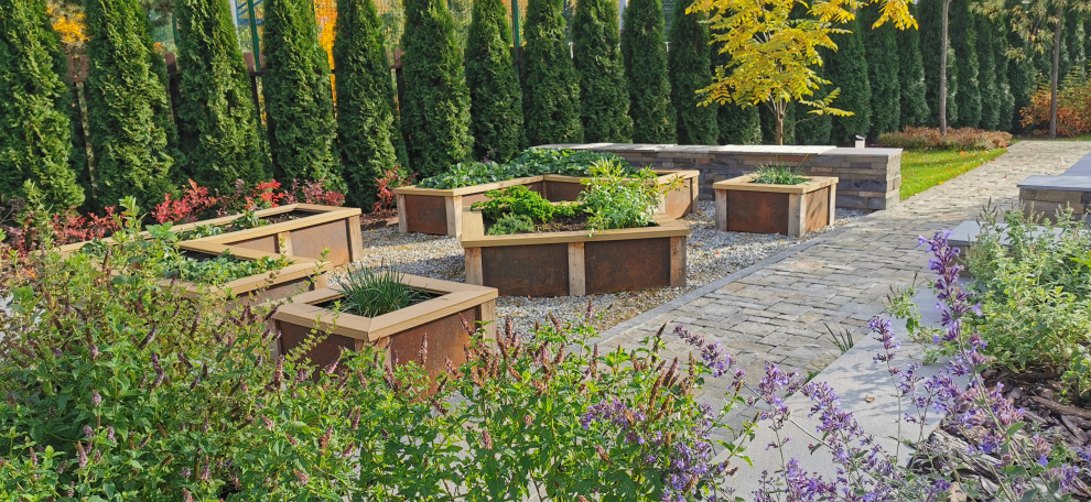 This is an example of a mid-sized contemporary backyard full sun formal garden for fall in Moscow with with raised garden bed and gravel.