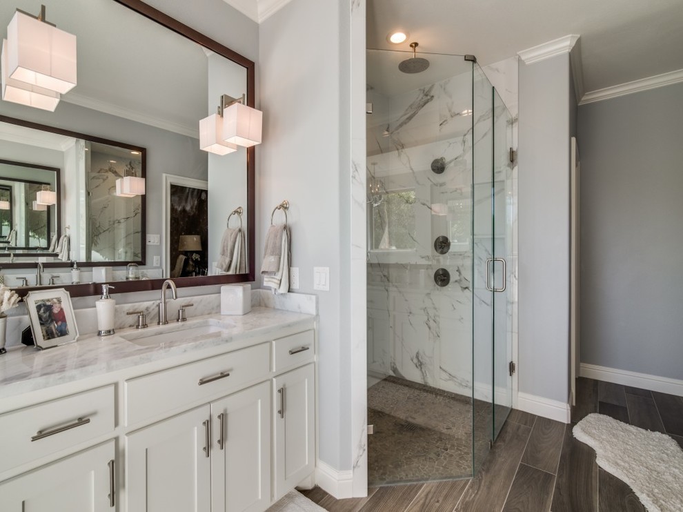 Design ideas for a transitional master bathroom in Dallas with shaker cabinets, white cabinets, grey walls, porcelain floors, an undermount sink, granite benchtops, brown floor, a corner shower, gray tile, white tile, marble and a hinged shower door.