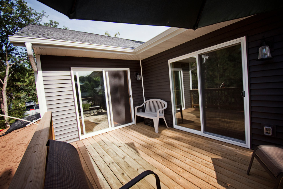 Example of a mid-sized mountain style side yard deck design with no cover