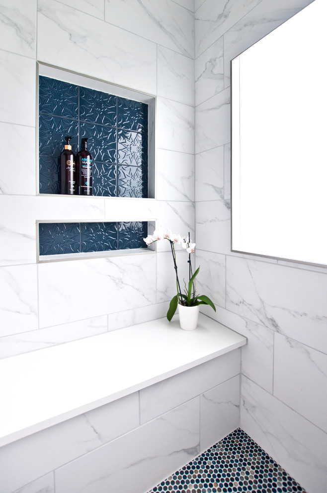 Photo of a mid-sized traditional master bathroom in Nashville with raised-panel cabinets, blue cabinets, an alcove shower, a two-piece toilet, white tile, porcelain tile, beige walls, porcelain floors, an undermount sink, engineered quartz benchtops, white floor, a hinged shower door and white benchtops.