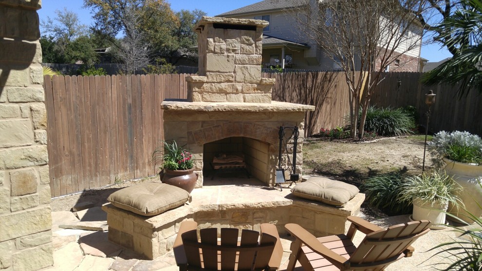 Design ideas for a mid-sized mediterranean backyard patio in Austin with a fire feature and natural stone pavers.