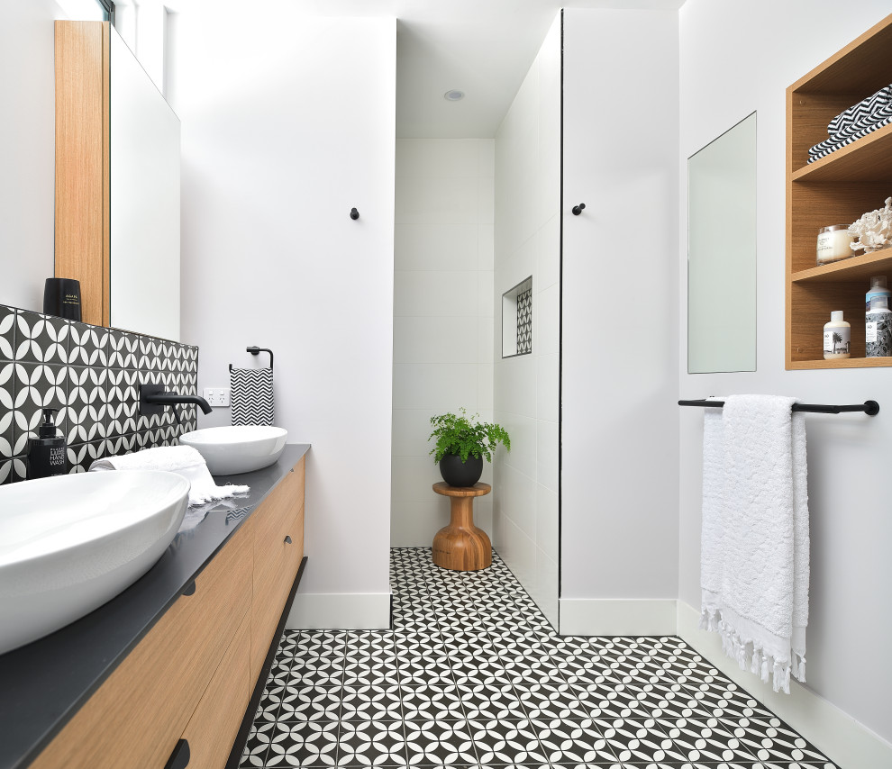 Inspiration for a contemporary master bathroom in Brisbane with flat-panel cabinets, medium wood cabinets, an open shower, black and white tile, a vessel sink, multi-coloured floor, an open shower, black benchtops and a floating vanity.