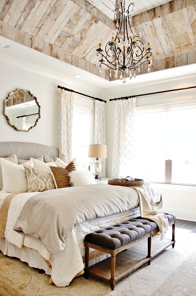 Large country master bedroom in Atlanta with white walls, dark hardwood floors and brown floor.