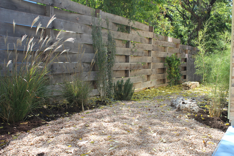 Design ideas for a contemporary backyard shaded garden in Austin with gravel.