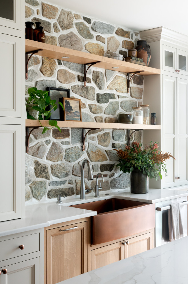 Example of a transitional kitchen design with an island