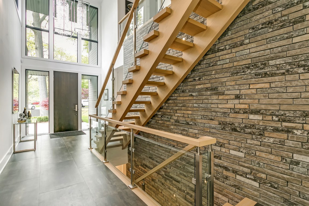 Example of a mid-sized transitional slate floor and gray floor entry hall design in Toronto with white walls
