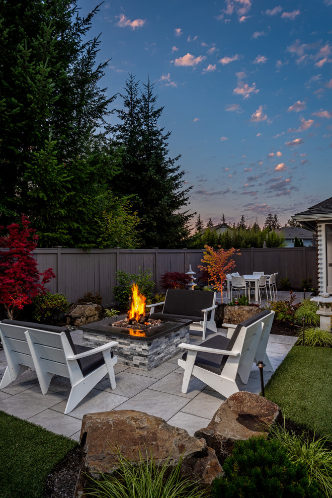 Inspiration for a mid-sized asian backyard partial sun garden in Seattle with a fire feature and natural stone pavers.