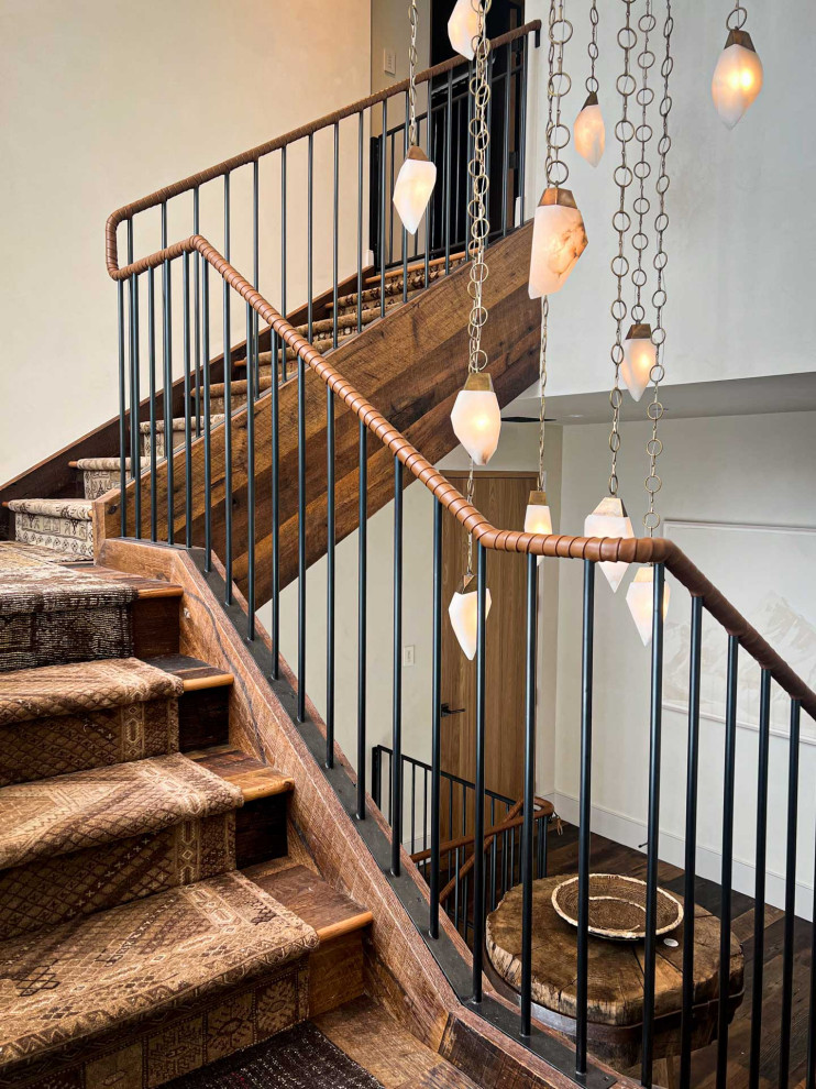 This is an example of a country wood l-shaped staircase in Other with wood risers and metal railing.
