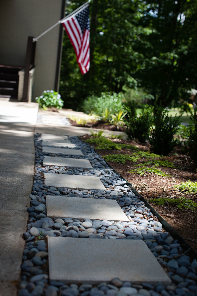 Design ideas for a large contemporary front yard partial sun driveway for fall in Atlanta with a garden path and gravel.