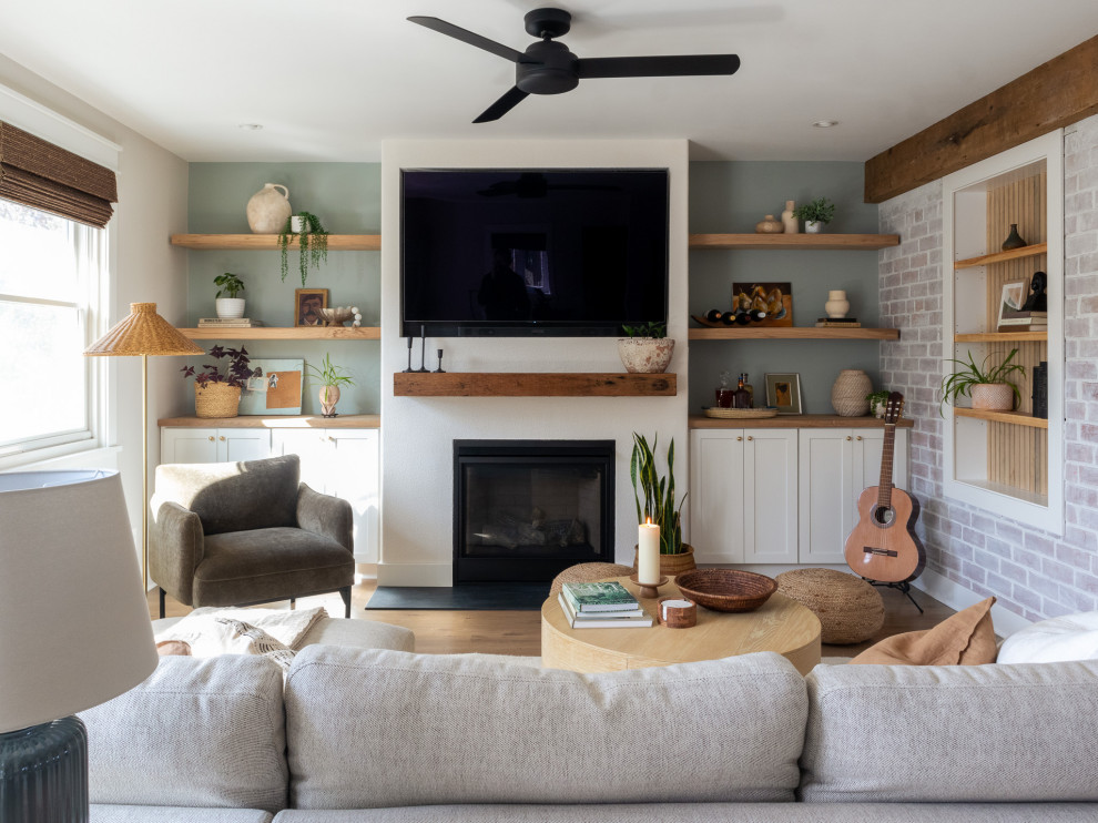 Inspiration for a medium sized classic games room in Baltimore with multi-coloured walls, medium hardwood flooring, a standard fireplace, a plastered fireplace surround, a built-in media unit, brown floors and brick walls.