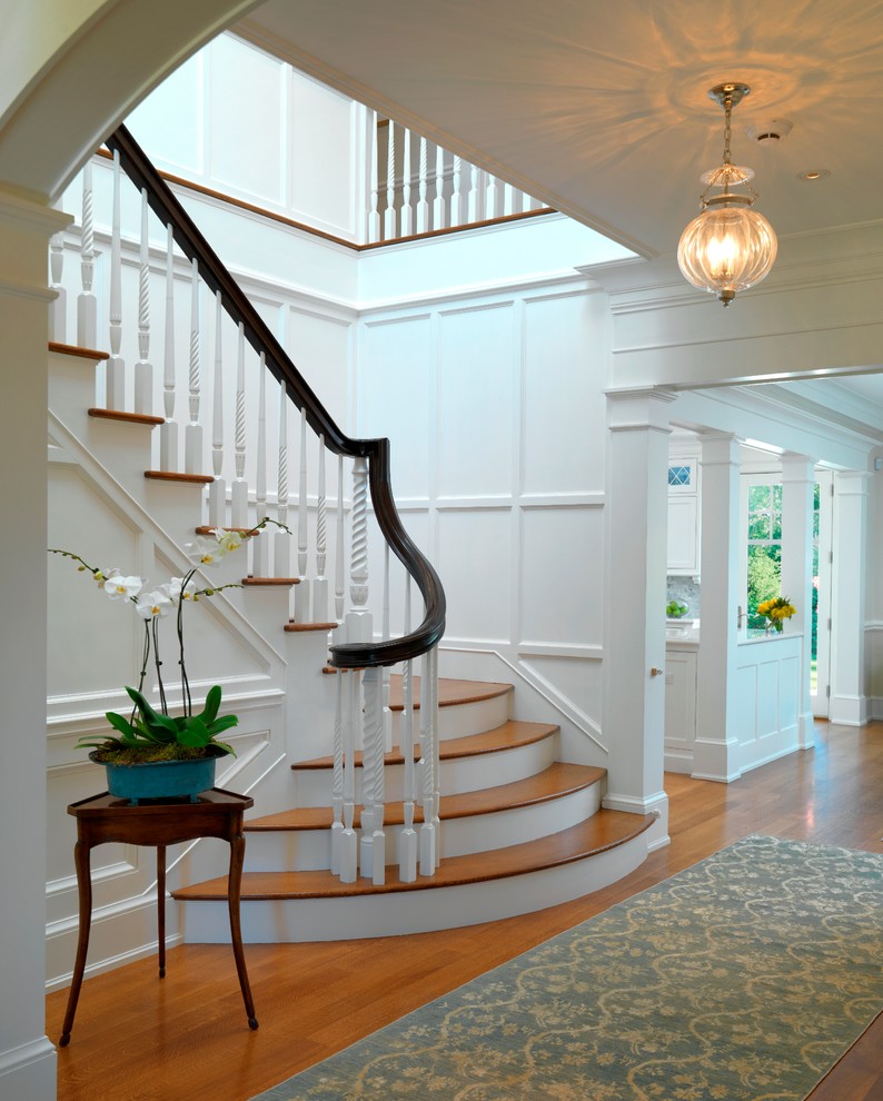 Traditional wood staircase in Boston with painted wood risers.
