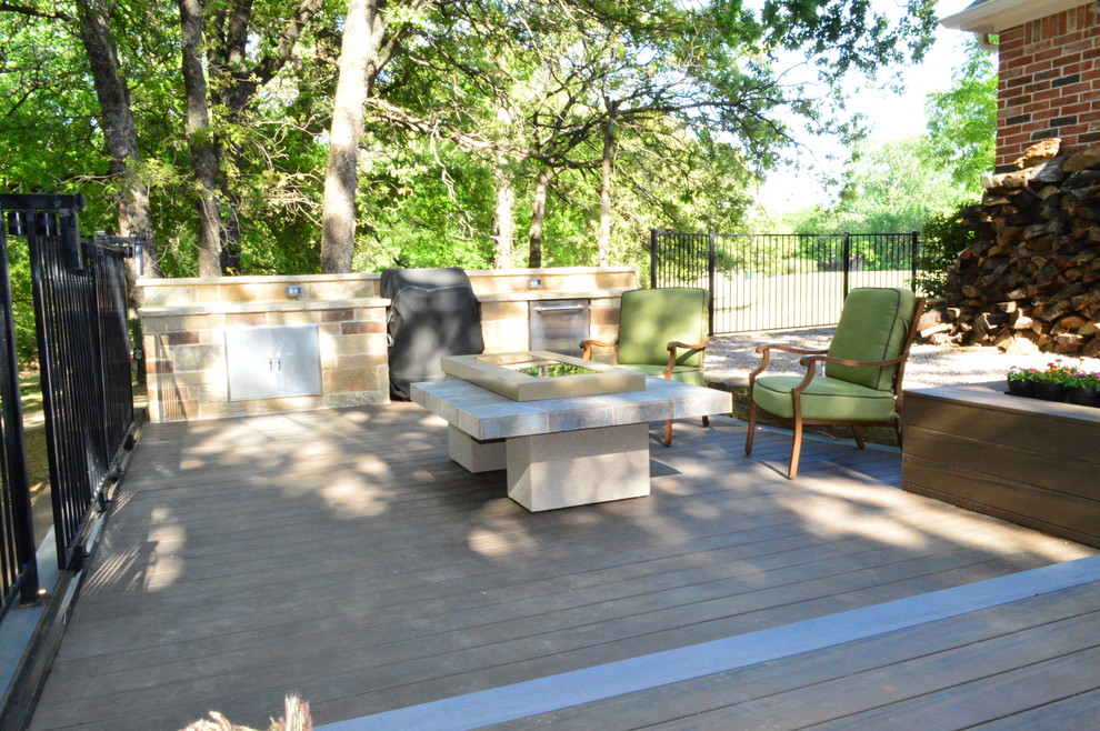 Inspiration for a large eclectic backyard deck in Dallas with an outdoor kitchen.