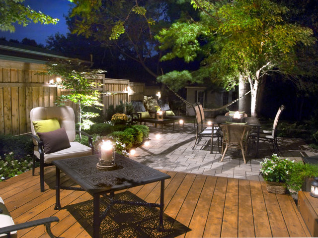 Photo of a large traditional backyard patio in Montreal with brick pavers, no cover and a fire feature.
