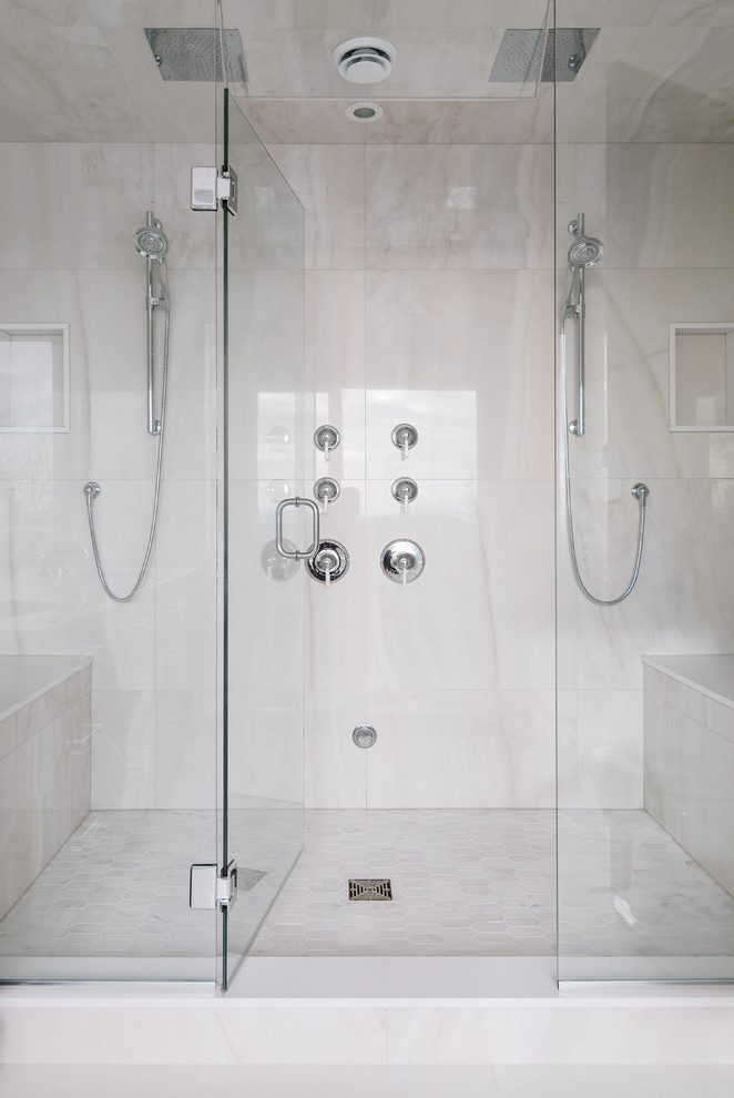 This is an example of a large contemporary master bathroom in Montreal with a double shower, white tile, porcelain tile and marble floors.