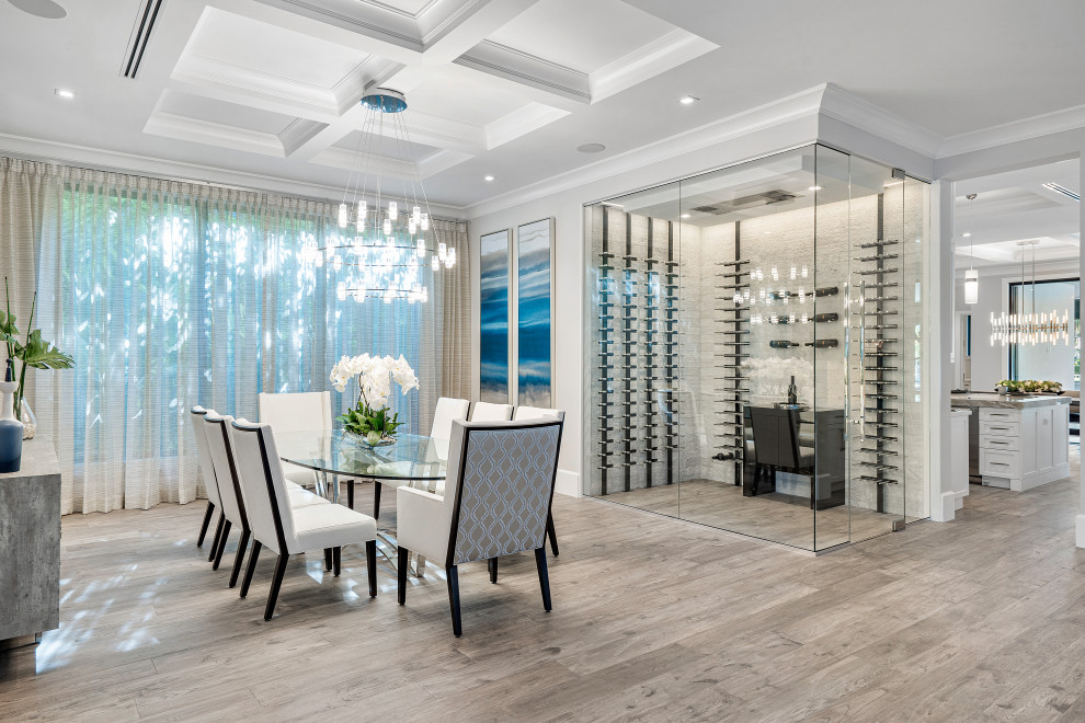 Photo of a large transitional open plan dining in Miami with white walls, light hardwood floors, no fireplace, beige floor, coffered and wallpaper.