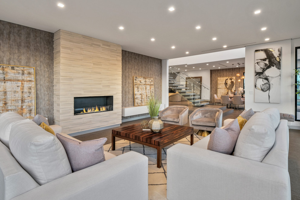 Photo of a contemporary open concept living room in Los Angeles with white walls, a ribbon fireplace and a tile fireplace surround.