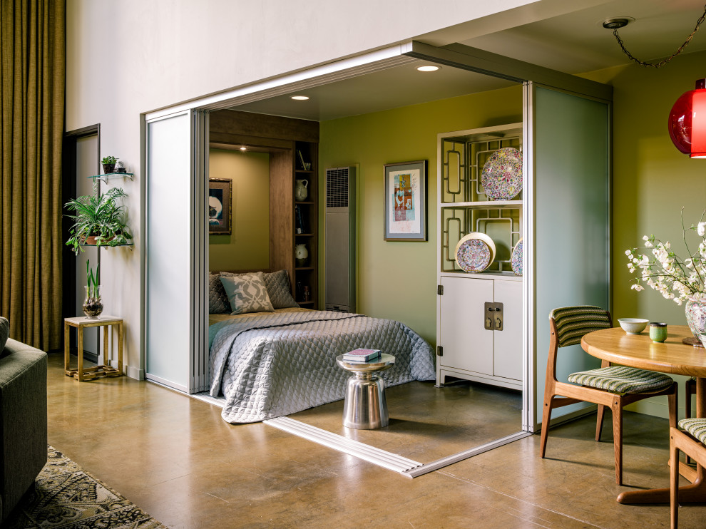 Ispirazione per una piccola camera da letto stile loft design con pareti verdi, pavimento in cemento, soffitto in legno e pareti in legno