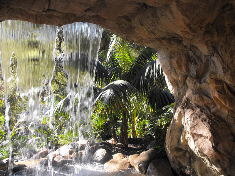Large mediterranean backyard partial sun garden in Santa Barbara with a water feature.