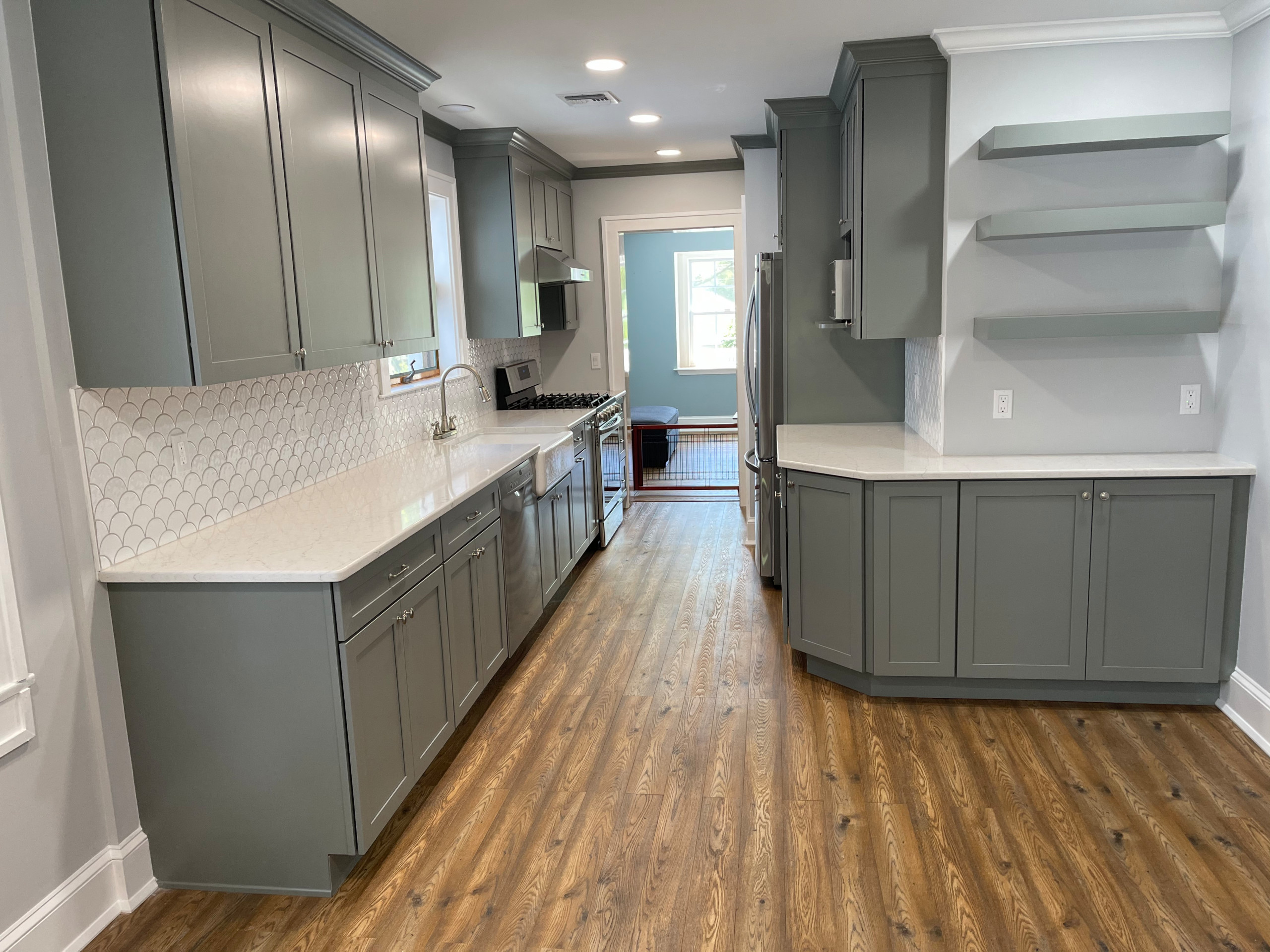 This kitchen has a fresh and casual feeling . Grey cabinets adds unique flare