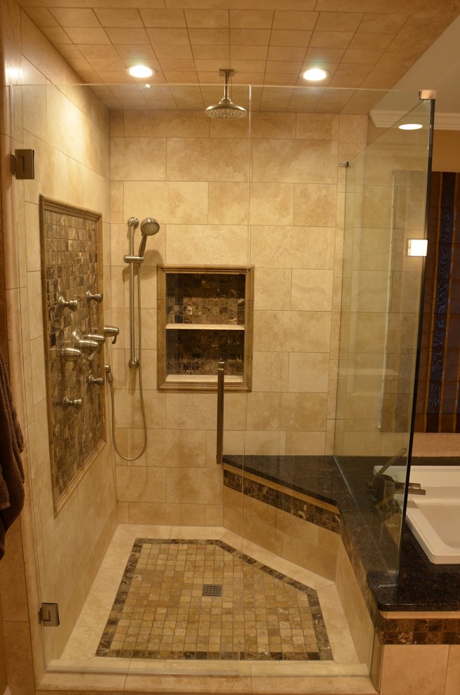 Inspiration for a mid-sized contemporary master bathroom in Atlanta with raised-panel cabinets, medium wood cabinets, a drop-in tub, a corner shower, a two-piece toilet, beige tile, stone tile, beige walls, travertine floors, an undermount sink and granite benchtops.