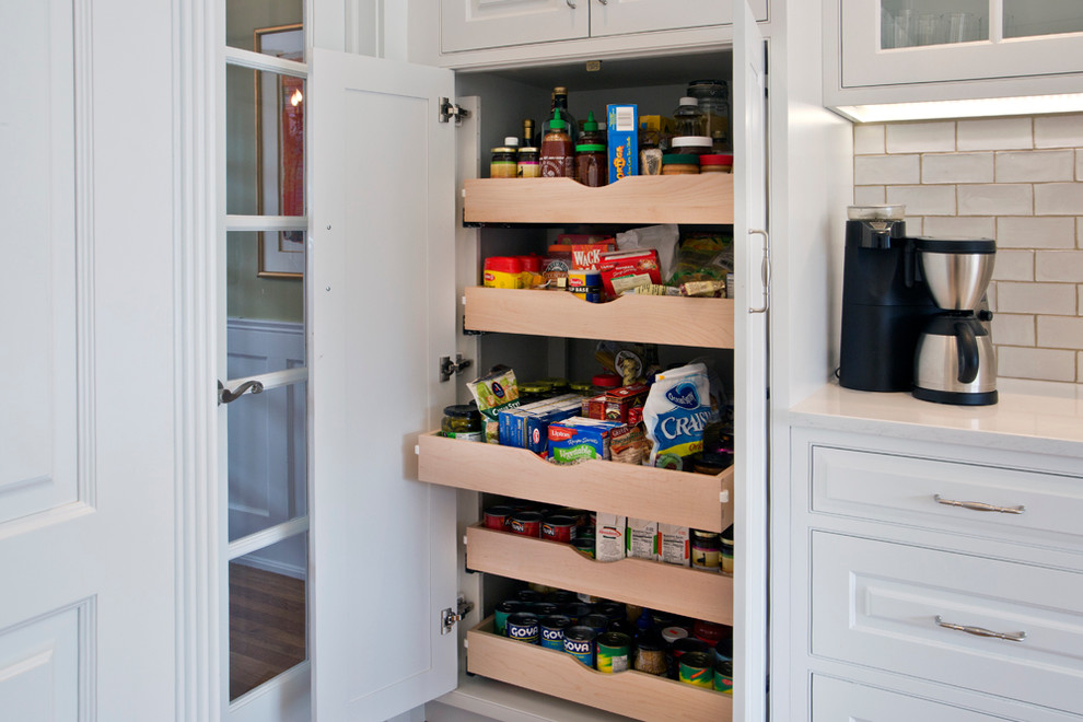 Eat-in kitchen - large transitional l-shaped medium tone wood floor eat-in kitchen idea with a farmhouse sink, white cabinets, granite countertops, white backsplash, stainless steel appliances, an island, raised-panel cabinets and subway tile backsplash