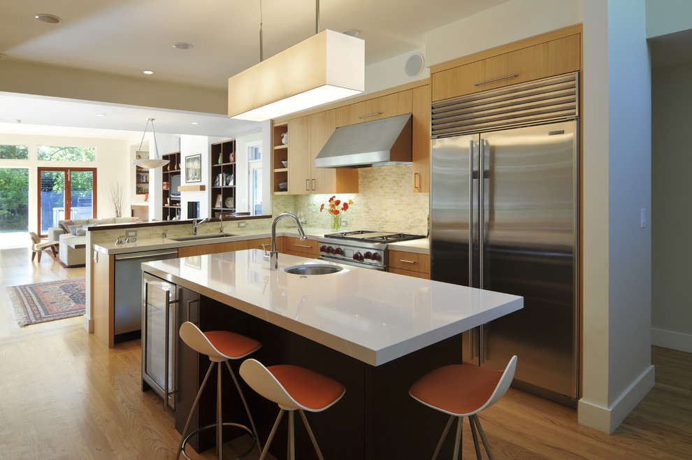 This is an example of a contemporary l-shaped open plan kitchen in San Francisco with stainless steel appliances, an undermount sink, flat-panel cabinets, medium wood cabinets, beige splashback and medium hardwood floors.
